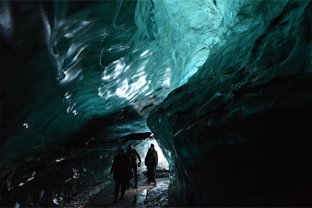 Kleine Gruppe auf Tour durch eine Eishöhle in Island.